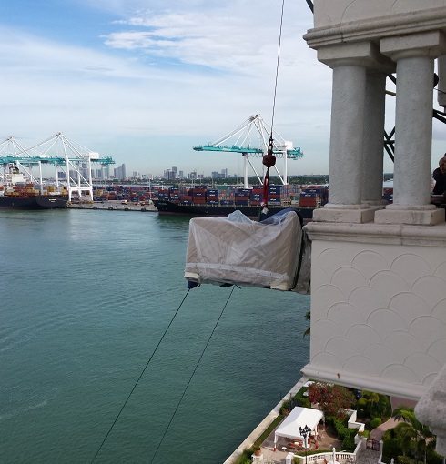 Couch being crane lifted to Miami penthouse
